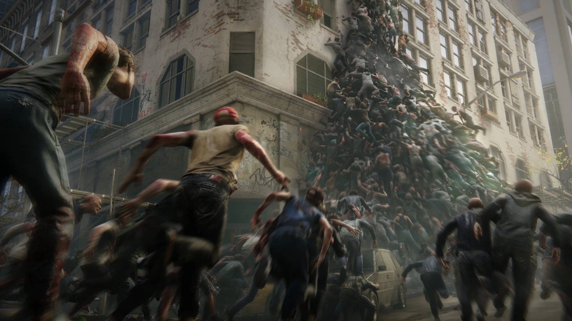A massive "pyramid" horde of dangerous zombies swarming a building in World War Z.